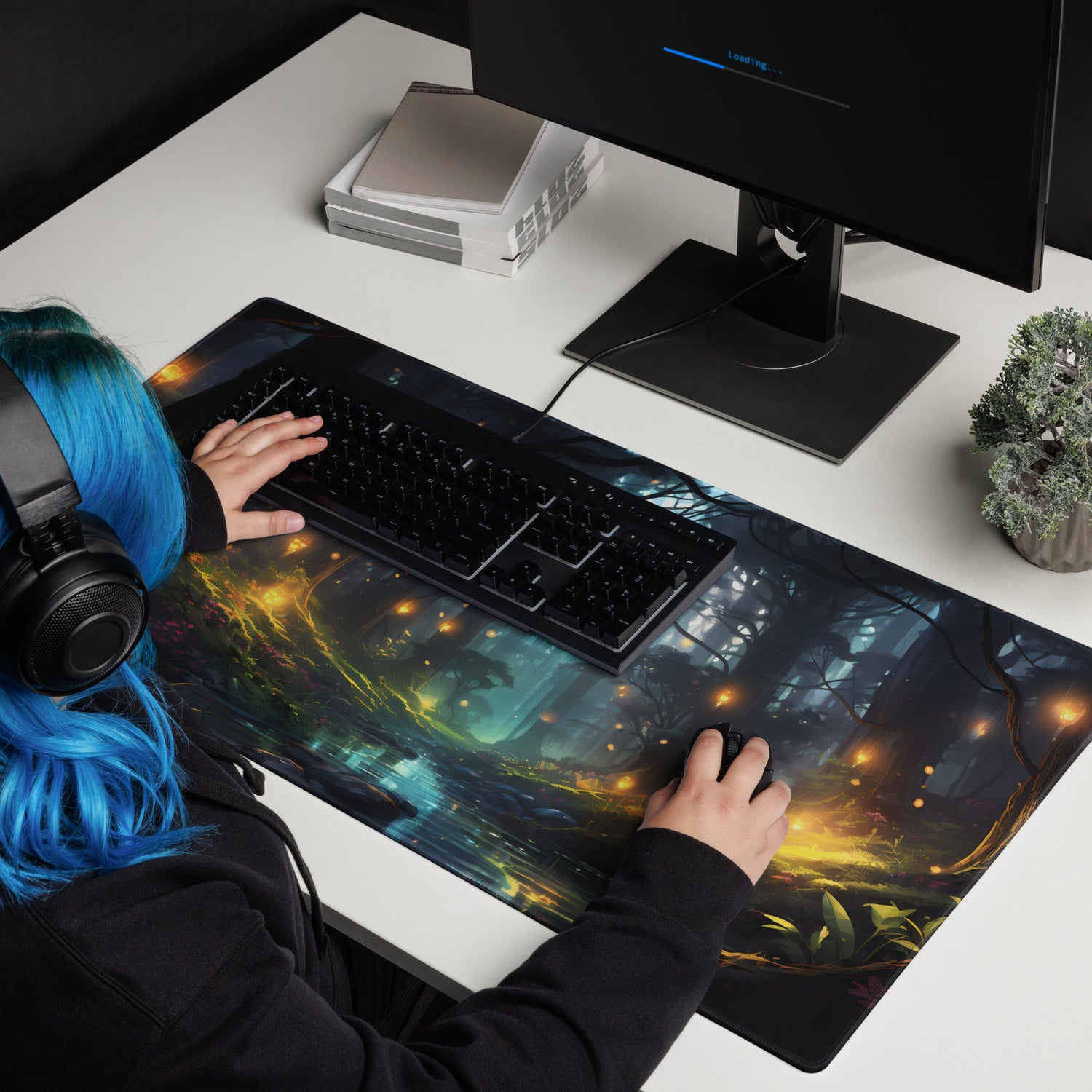 A blue-haired gaming girl using her new gaming mousepad that has a fantasy forest image on it. 